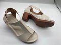 Women's peep toe wedge sandals with buckle detail, low heel, on a white background.