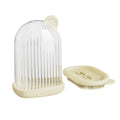 Compact PET travel soap dish in cream white, with a bar of soap on top