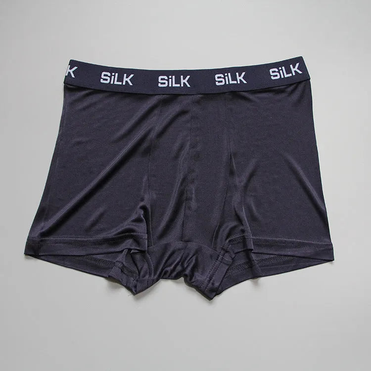 Men's loose-fitting silk shorts in navy blue on a mid-waist.