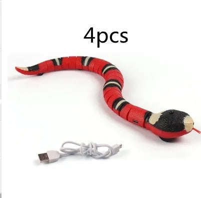 Smart sensing interactive electronic snake cat toy on a floor, showing segmented plastic body and USB charging port.