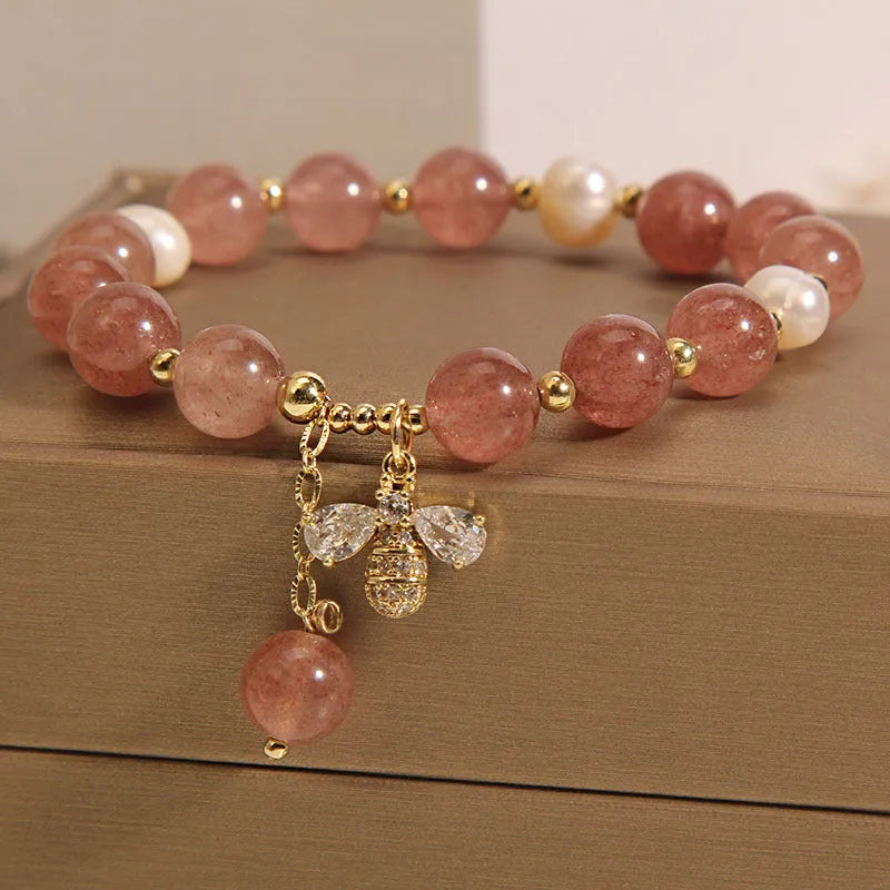 Women's bracelet with freshwater pearls, strawberry quartz stones, zircon accents and alloy bee charm