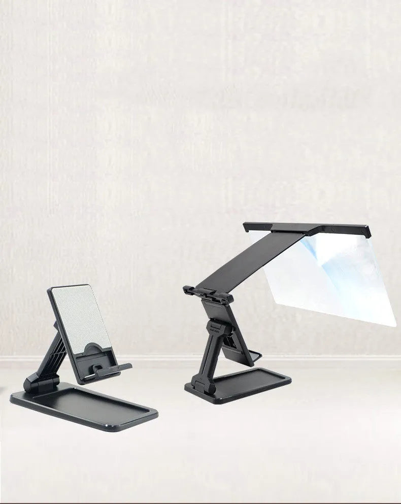 Black folding mobile phone screen magnifier with detachable phone holder on a desk.