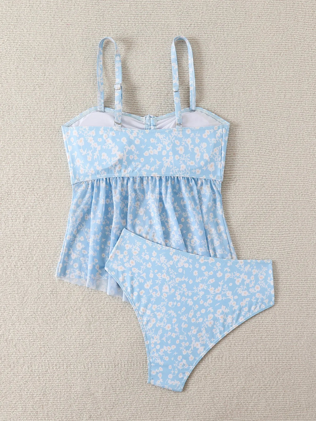 Light blue floral women's swimsuit set with shoulder straps and backless design, available in sizes S to XL