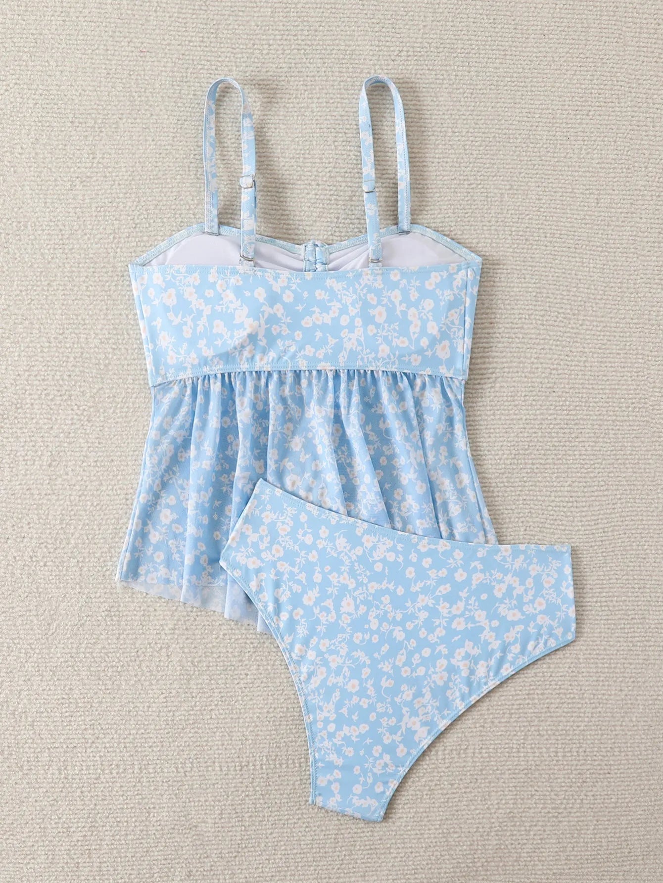 Light blue floral women's swimsuit set with shoulder straps and backless design, available in sizes S to XL