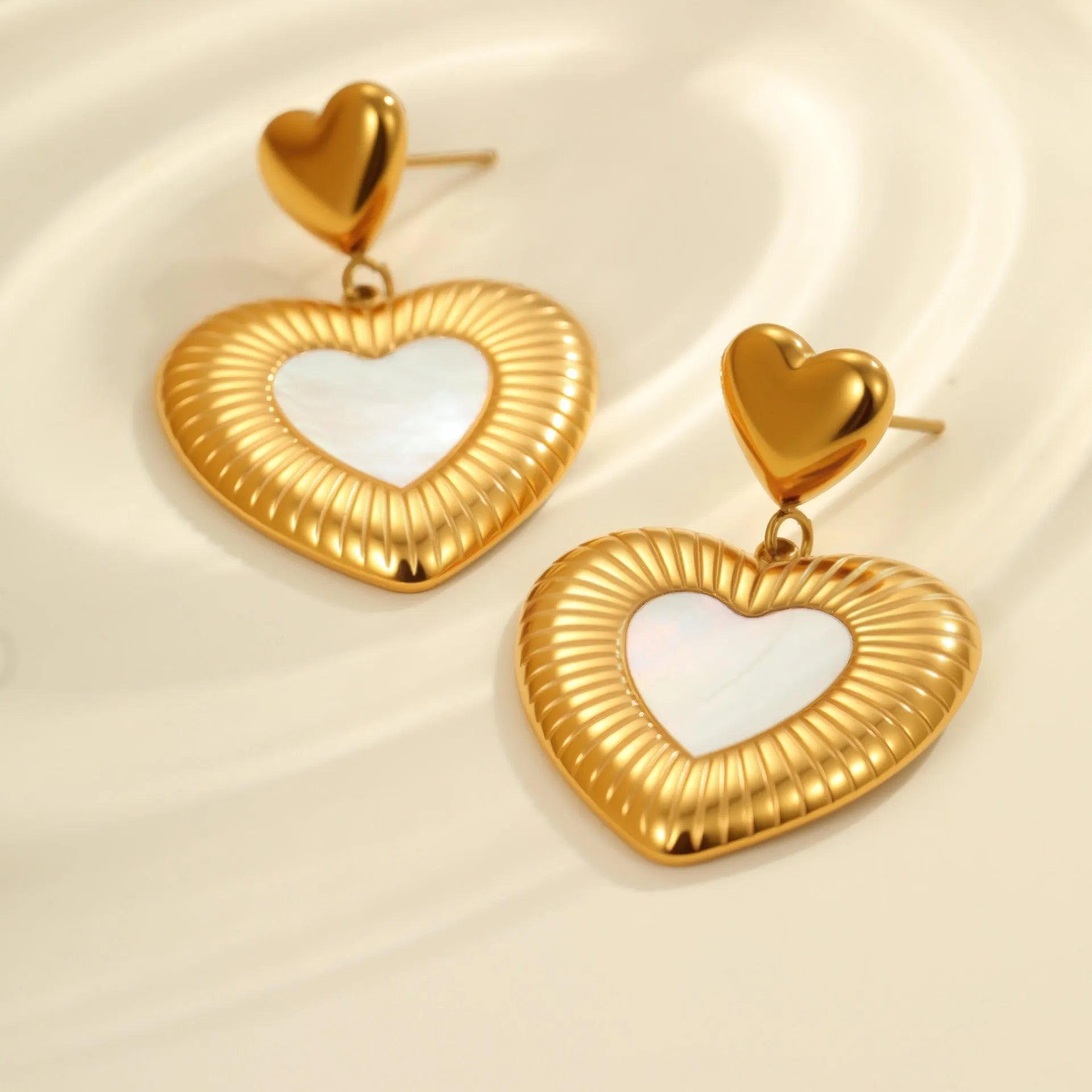 Gold electroplated heart-shaped earrings on stainless steel backing for women's fashion wear