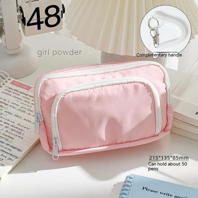 Double-layer pencil case in blue showing internal compartments and a top carry handle