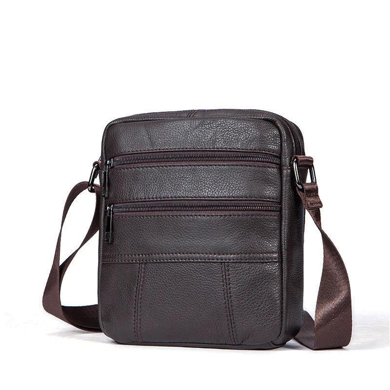Men's black genuine leather vintage shoulder bag showing zipper opening and soft handle.