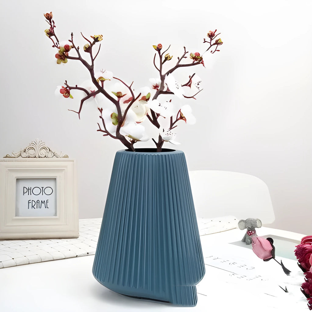 White melamine plastic decorative flower vase measuring 16cm by 20cm on a desktop