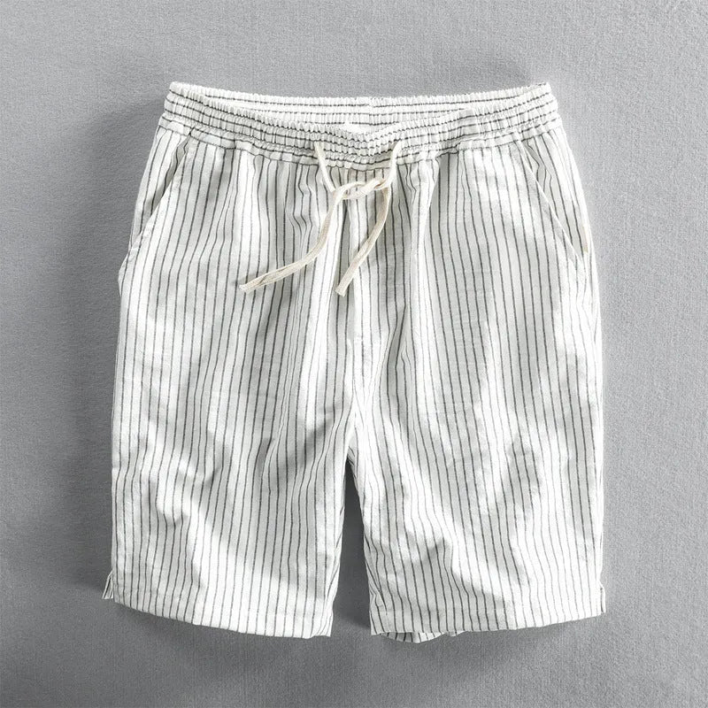 Man wearing black and white striped loose-fit casual cotton shorts with a mid waist.
