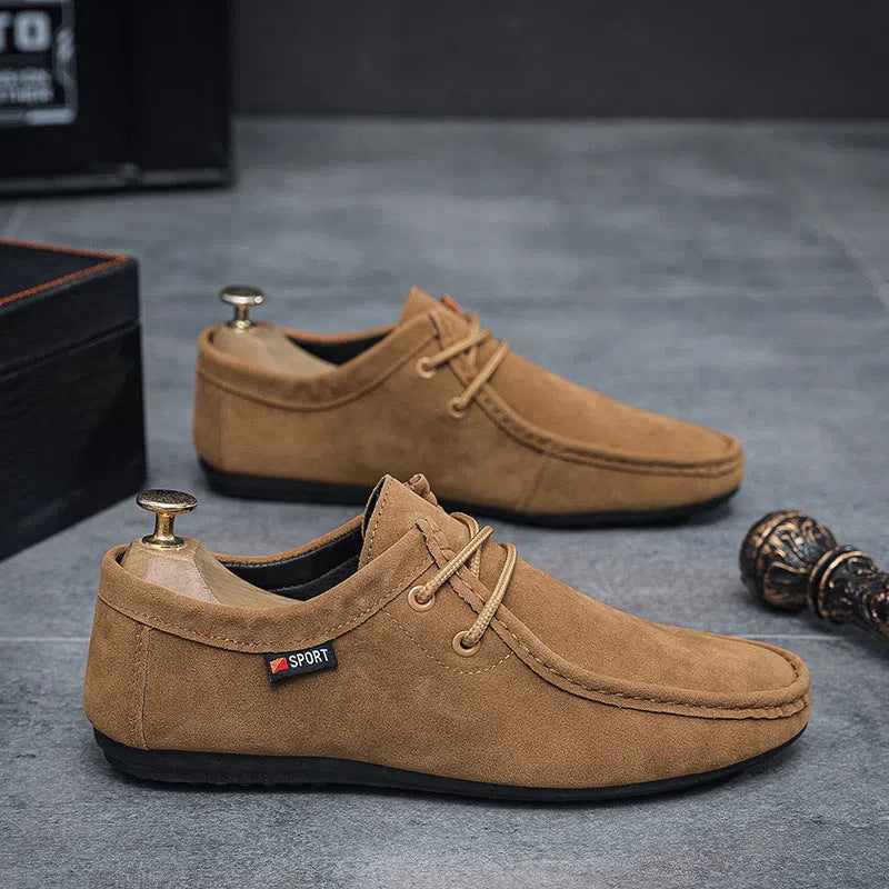 Men's black slip-on loafers with synthetic PU upper, stitched detailing, and non-slip plastic sole