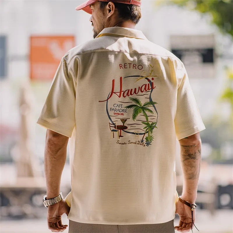 Light apricot men's shirt with bamboo and flower pattern and a Cuban collar.