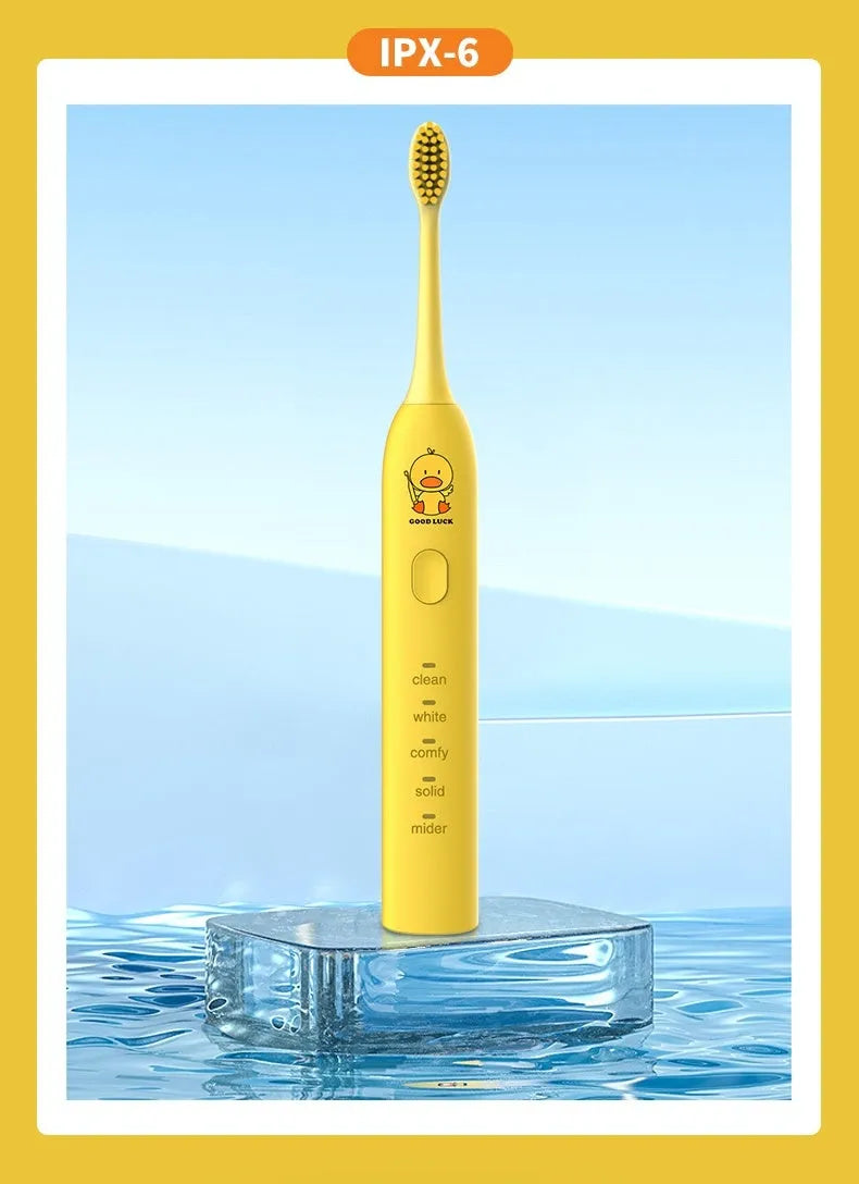 Small Yellow Duck rechargeable electric toothbrush in yellow, showing soft bristle head and USB port.