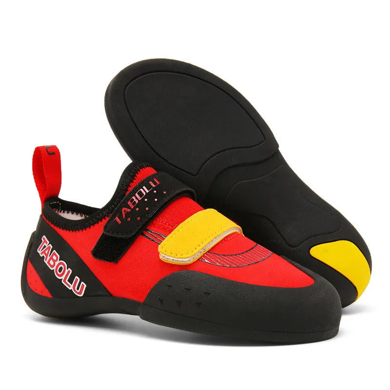 A pair of black and red rock climbing shoes with Velcro straps and a rubber sole.