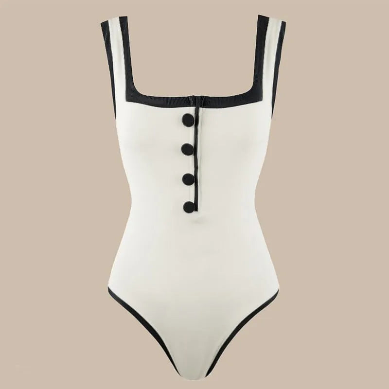 Black and white colour matching one-piece swimsuit with classic style belly coverage, backless design