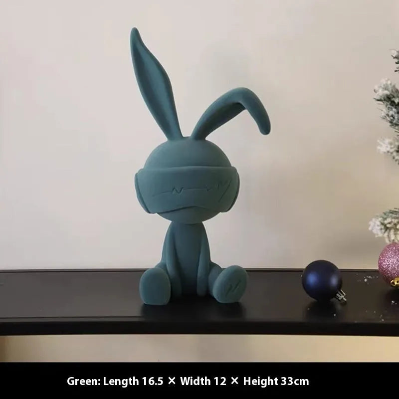Green suede blindfold rabbit resin table ornament on wooden surface