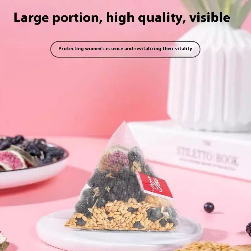 Black wolfberry mulberry fig flaxseed herbal tea packs and free cup on table