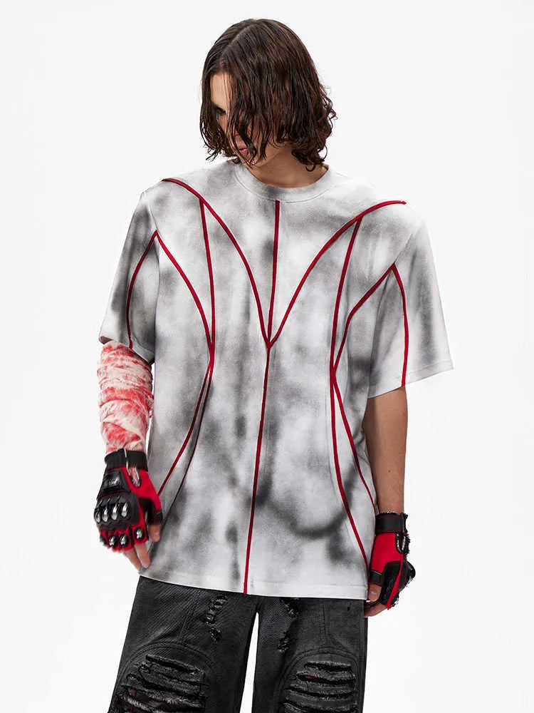 Short sleeve t-shirt with padded shoulders and raised line patchwork design on a round neck.