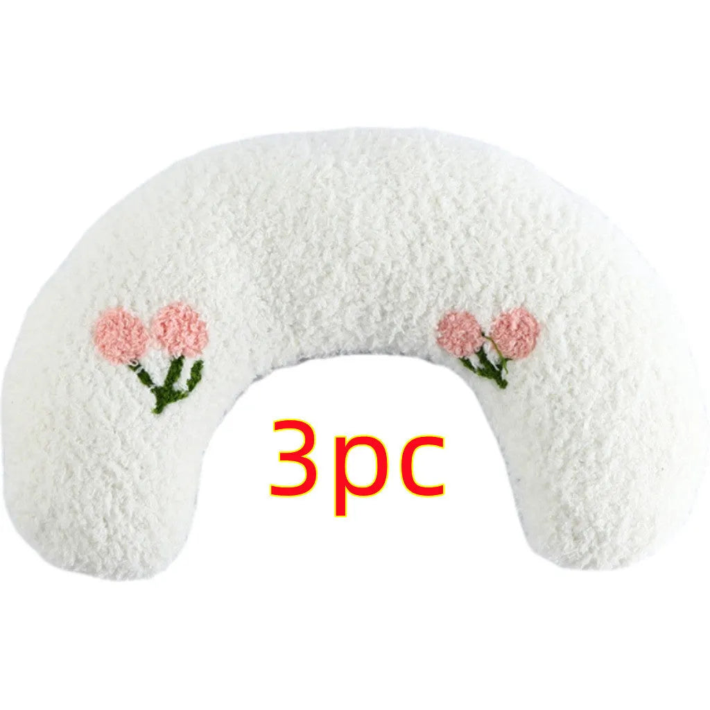 Small half-donut shaped plush pet pillow in blue, showing U-shaped design for cat or small dog neck support.