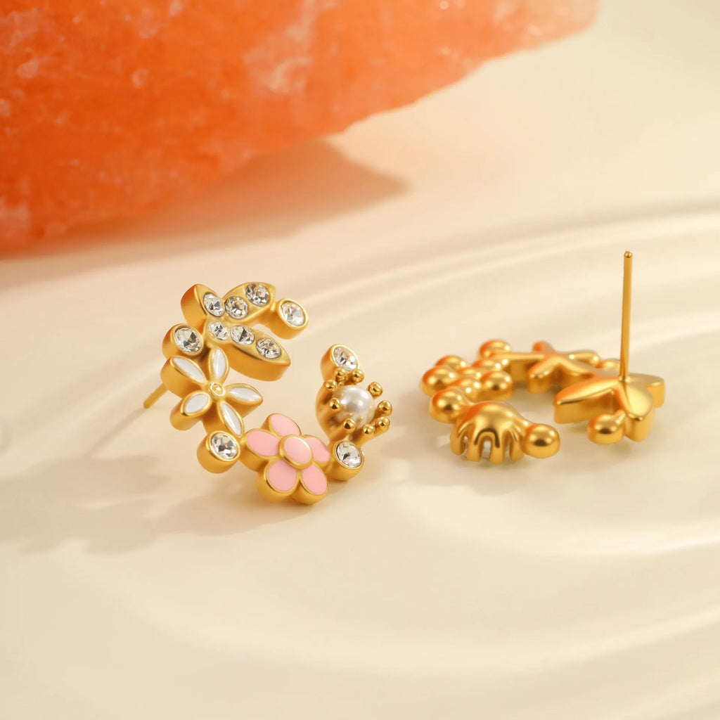 Close-up of colourful oil finish flower-shaped stud earrings with petal details on a stainless steel post.