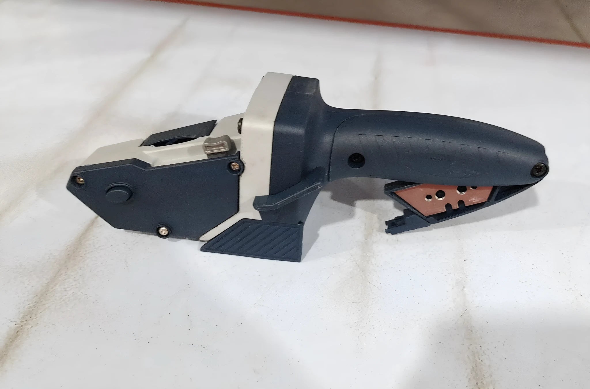 Blue multi-functional woodworking cutter with one-press lock for cutting gypsum board, foam board, and cardboard.