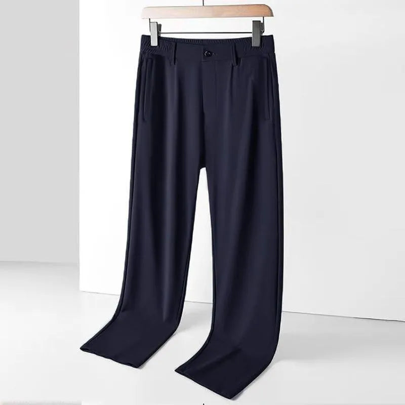 Man wearing black loose-fit ice silk straight leg casual trousers.