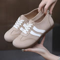 Women's vintage canvas sneakers in dark red with a soft rubber sole and round toe.