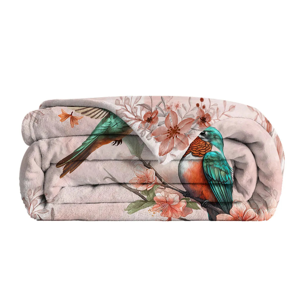 Hummingbird floral fleece throw blanket in pink flannel velvet, shown on sofa with hemmed edges