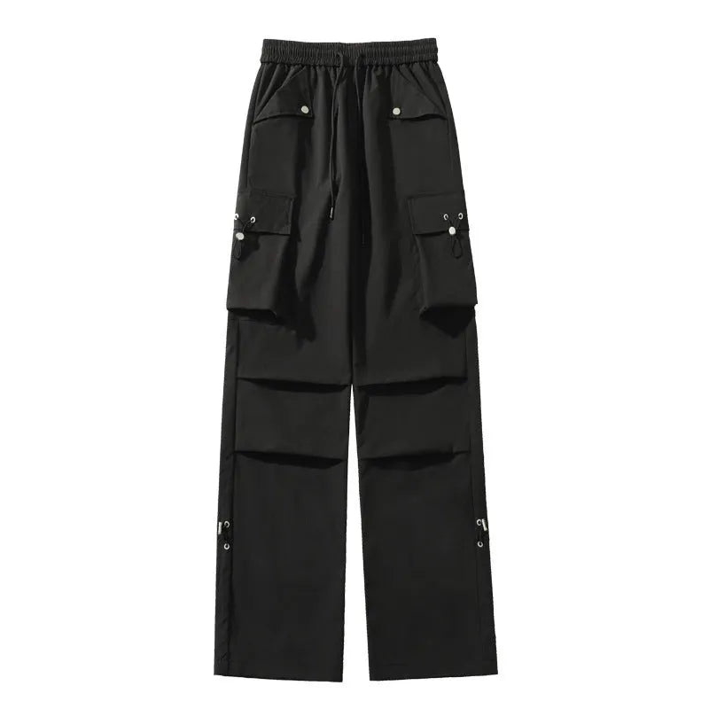Women's plus size straight-leg waterproof trousers in black, showing drawstring waist and loose fit.
