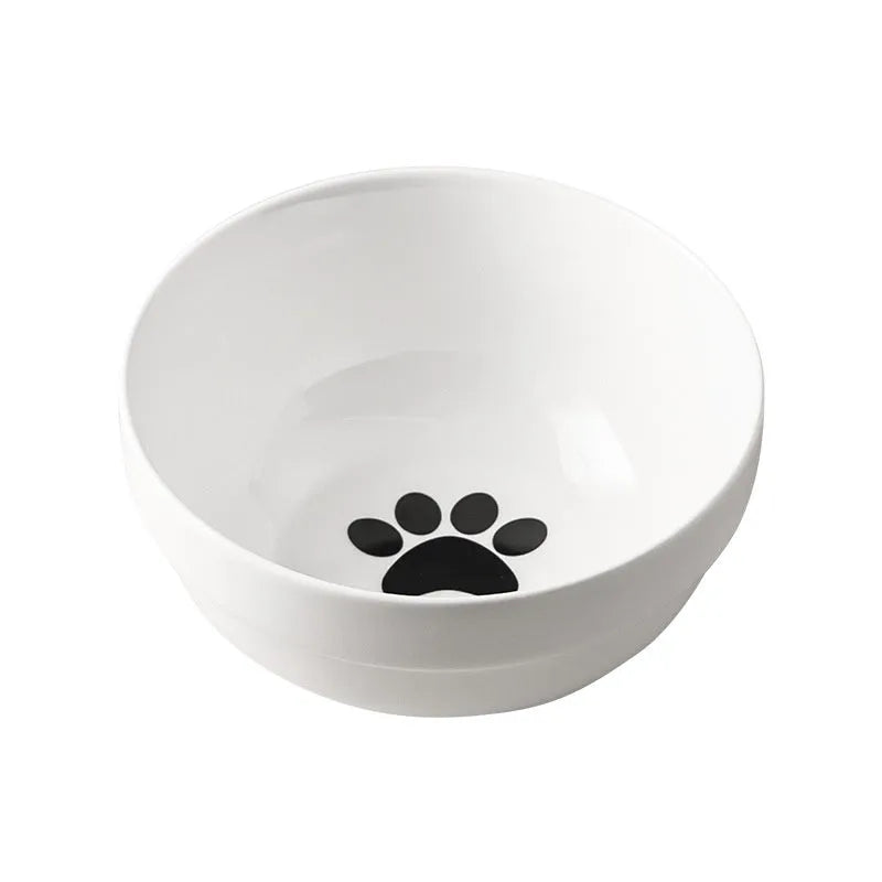 White ceramic cat bowl with cat paw print design on a black iron frame stand