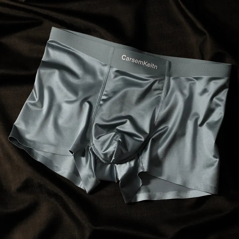 Men's solid colour ice silk seamless underwear laid flat, showing its knit construction.