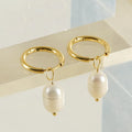 Pair of gold geometric earrings with pearl detail on titanium steel posts