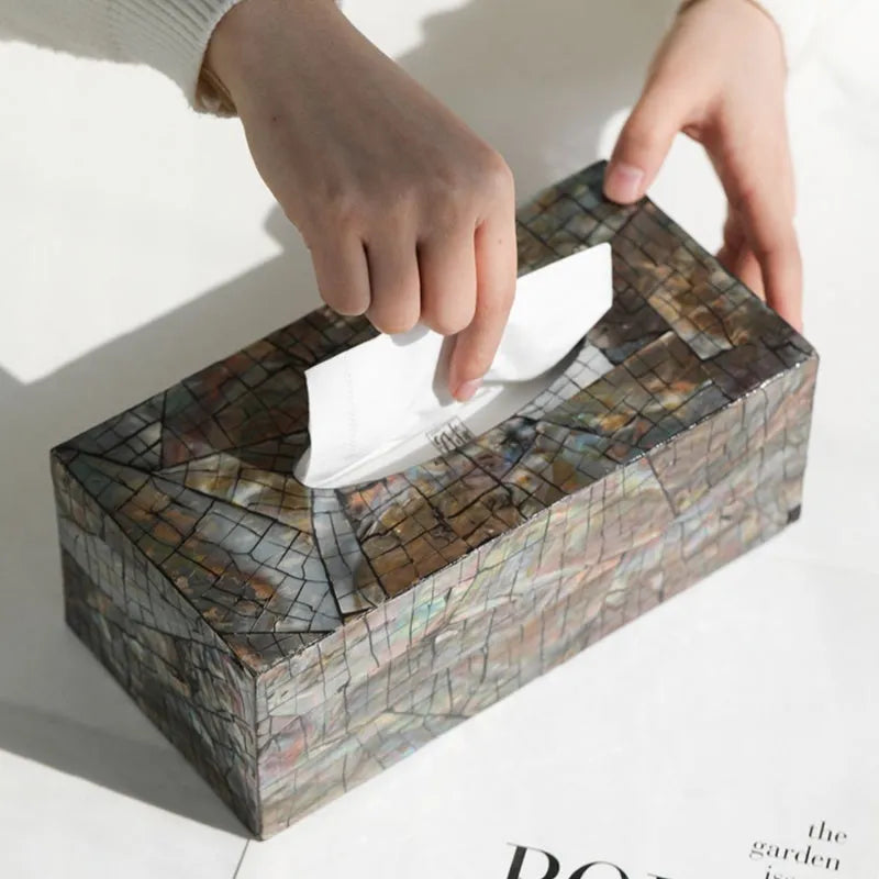 Black natural shell tissue box storage organiser with removable compartment on a coffee table.