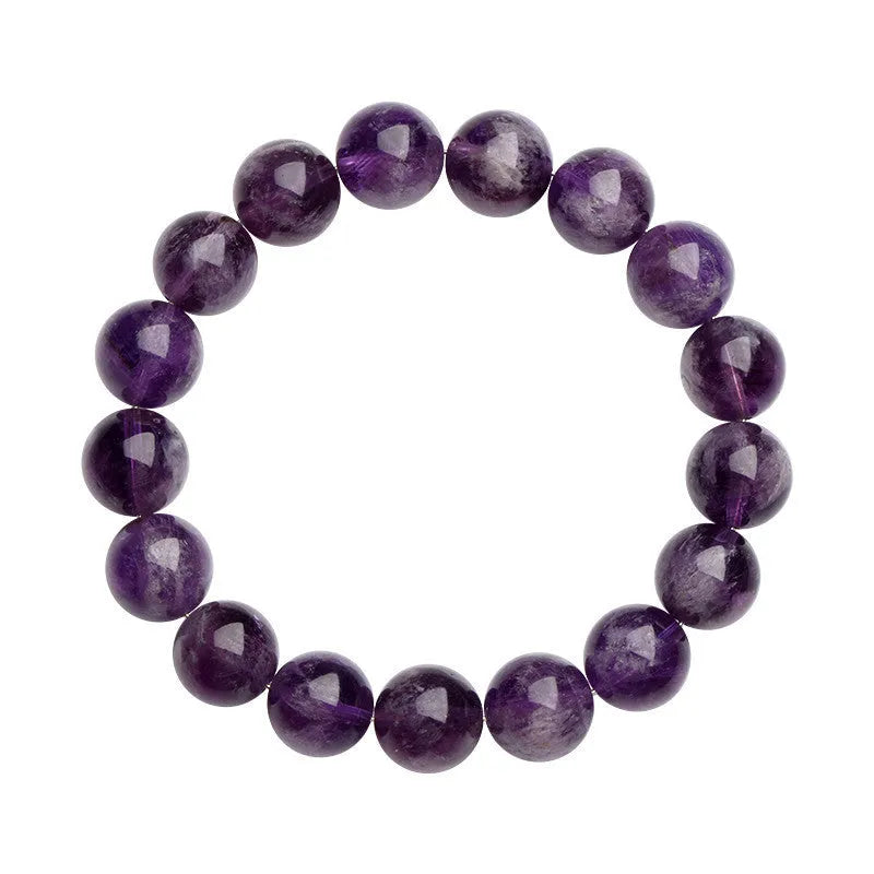 Natural feather amethyst crystal bracelet with scattered purple beads on a white background.