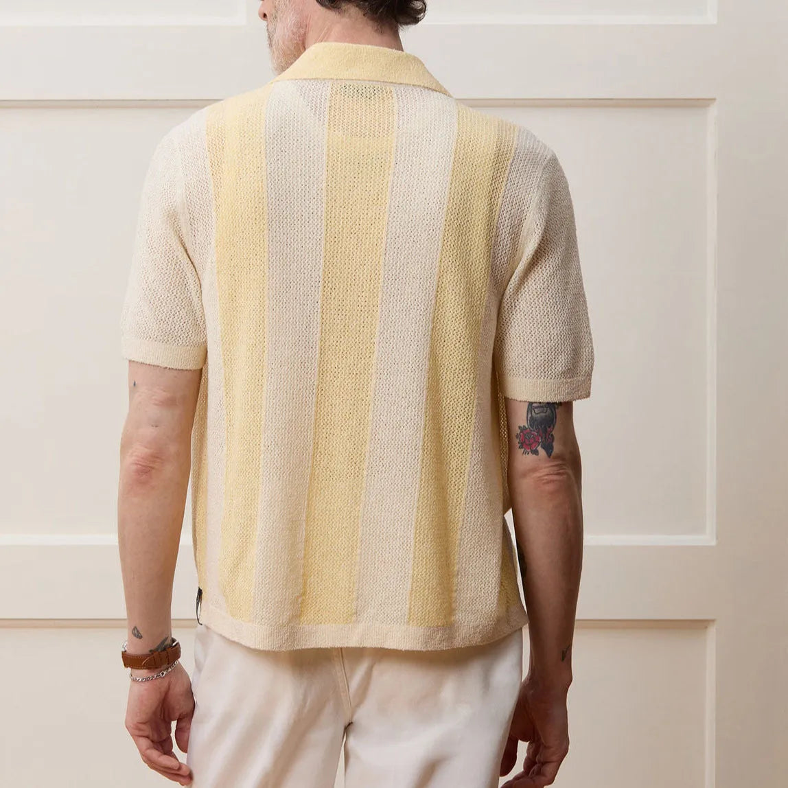 Yellow men's casual polo shirt with hollow-out detailing and an asymmetric short sleeve hem.