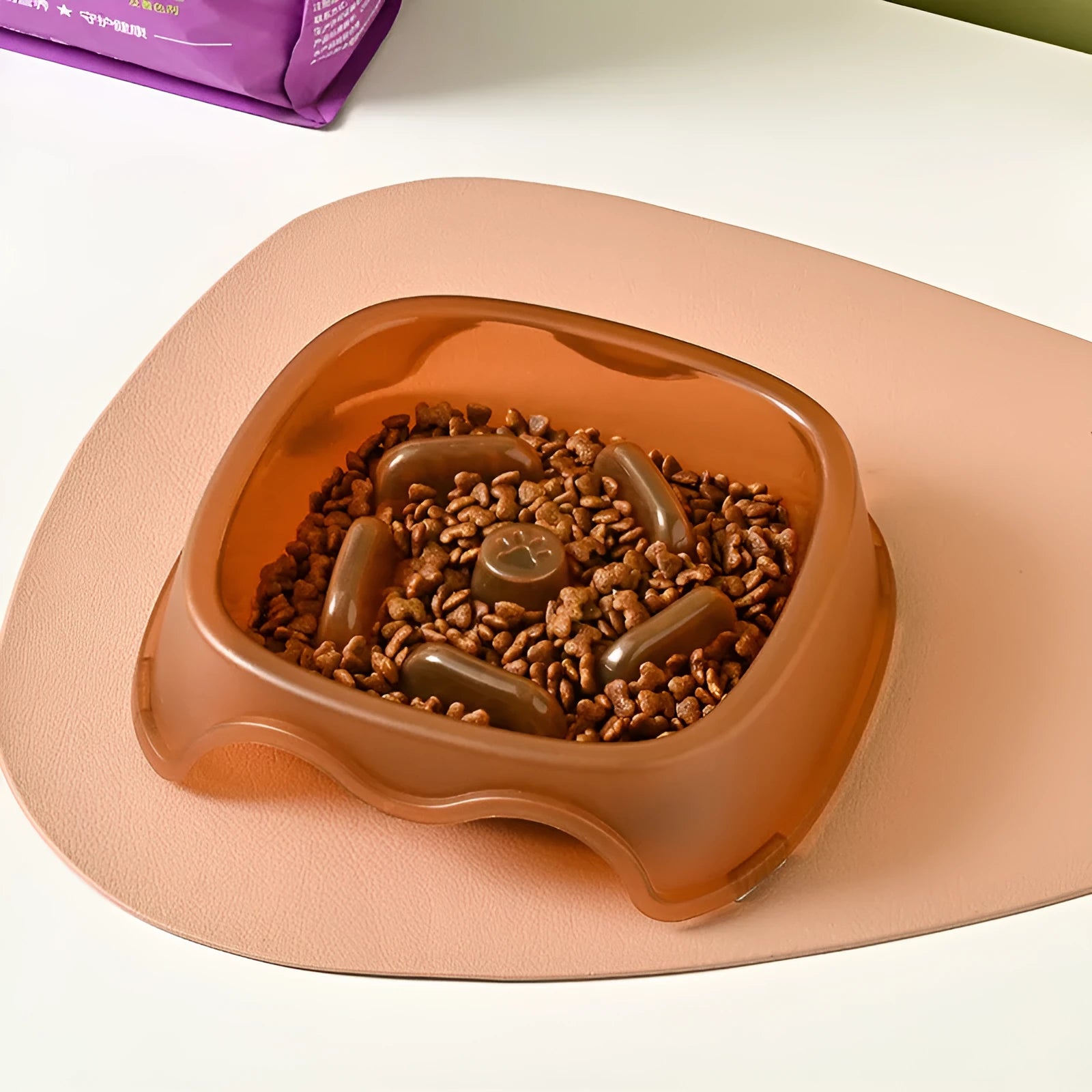 Blue plastic slow feeder dog bowl for anti-choking feeding on a plain surface.