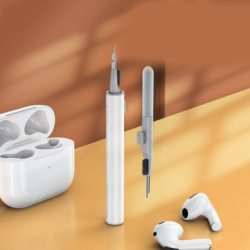 White 3-in-1 headset cleaning pen with ABS, metal, and sponge tips on blue background