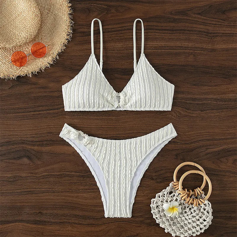 White women's v-neck swimsuit with sleeveless top and split shorts on mannequin