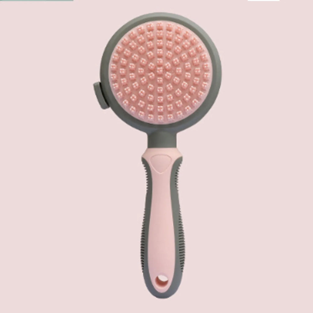 Pink and green double-sided cat grooming brush with flea comb attachment and release button