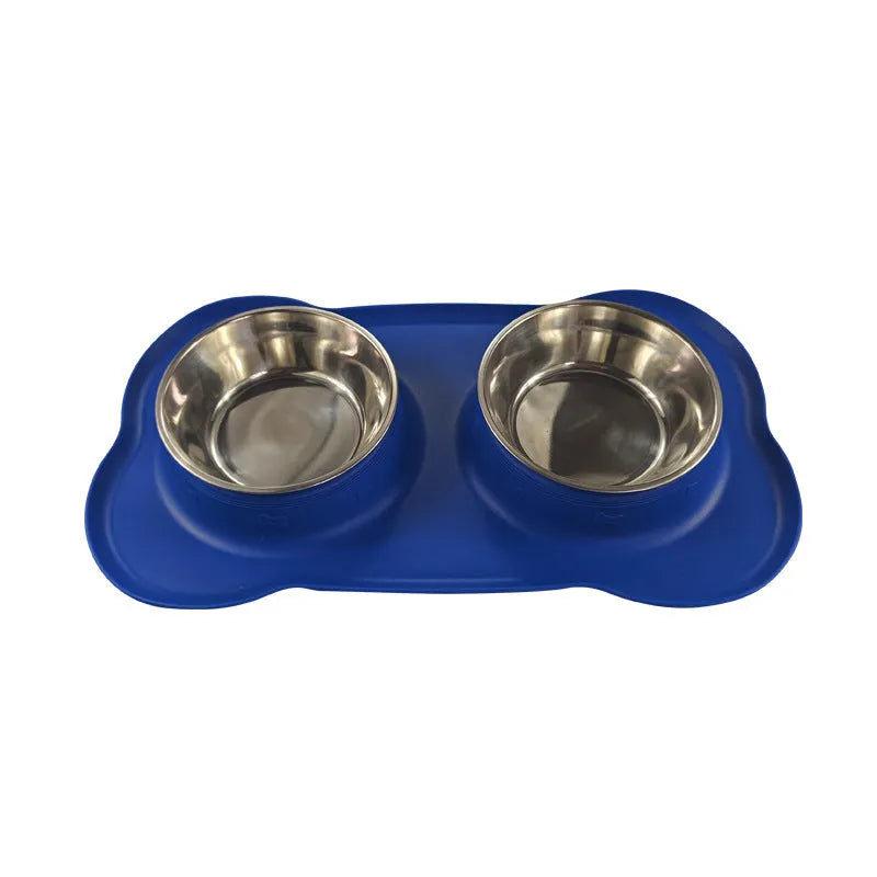 Large silicone double dog bowl in blue with two compartments for food and water on a kitchen floor.