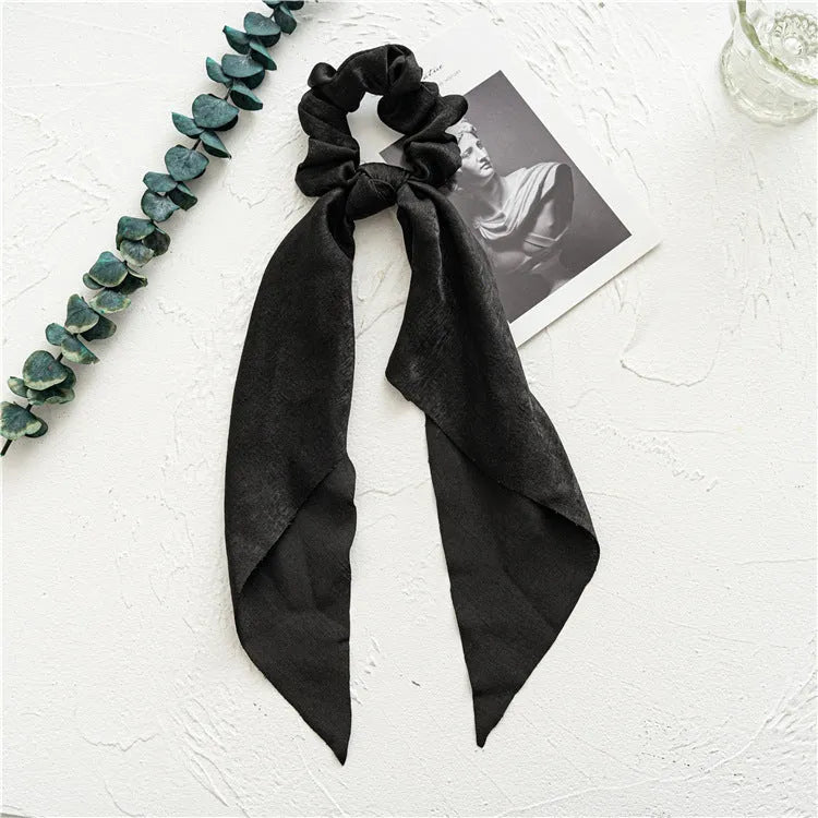 Long dark green floral cloth ribbon hair tie with a large metal ring closure for ponytails.