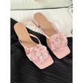 Women's cream-white satin sandals with a chunky block heel, square toe, and a single strap across the foot.