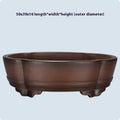 Green classical purple clay bonsai pot with low-profile rectangular shape on a tabletop.