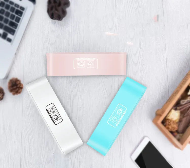 Blue rectangular LED digital alarm clock with multicolour light settings on a wooden surface.