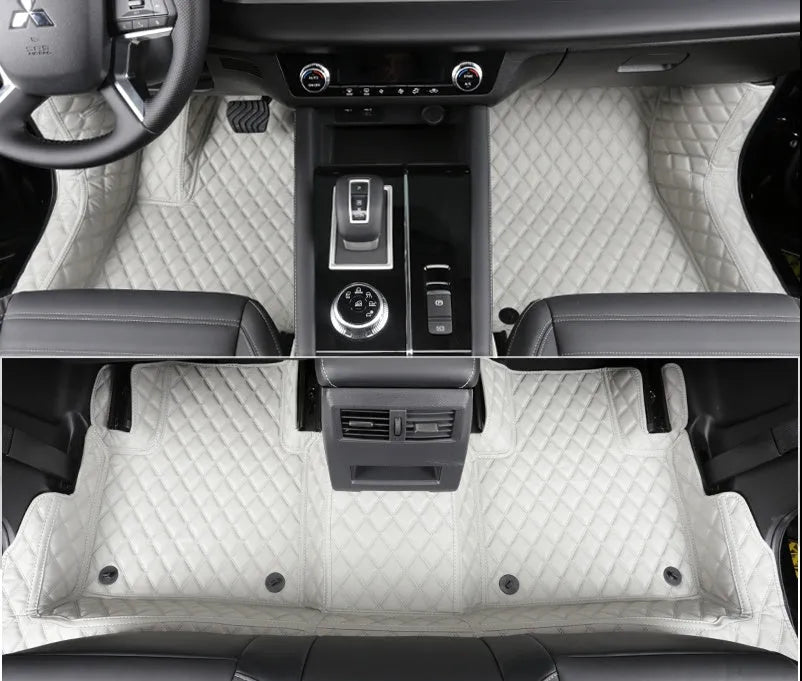 Custom black PU floor mats installed in a Mitsubishi Outlander footwell.