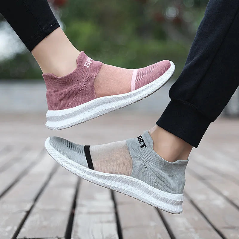 Flyknit casual sock shoes in khaki colour with lace-up front and tassel detail on a flat MD sole.