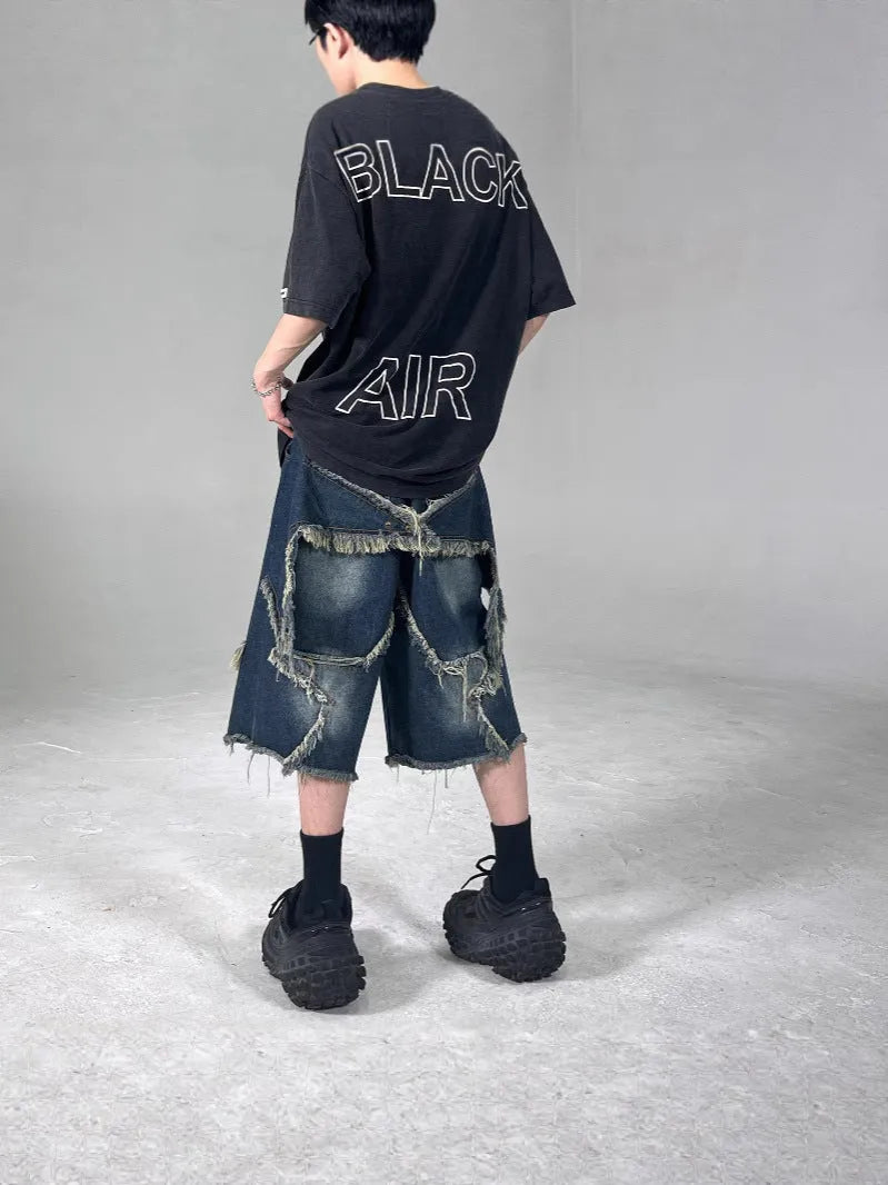 Blue denim shorts with frayed five-pointed star decoration in loose retro style