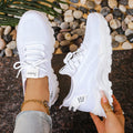 Women's low-top sports shoes with mesh upper and white sole in multiple colours.