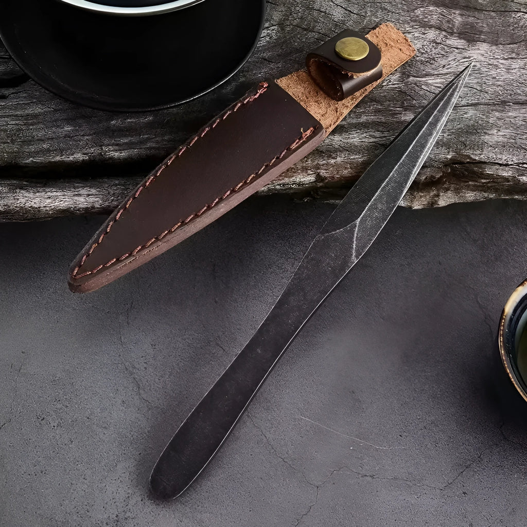 Black stainless steel hand pry tea knife with pointed blade on plain background