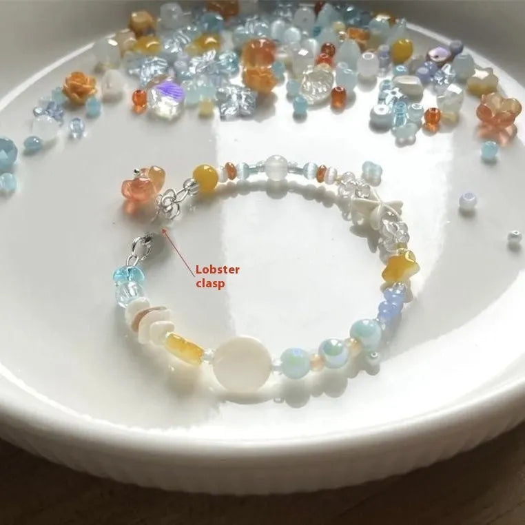 Orange and sea tone mixed material bracelet with diamond shapes and round elements
