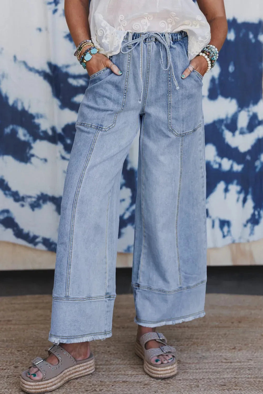 Beau blue women's wide leg denim trousers with a drawstring waist and raw hem seam detail